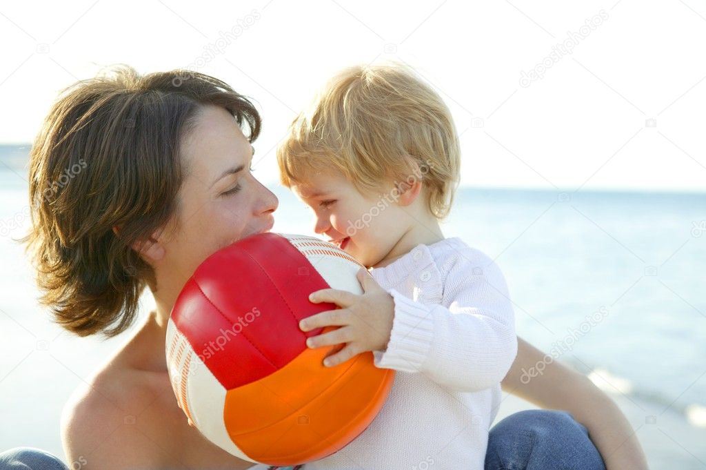 Mother and son on the sea, football ball