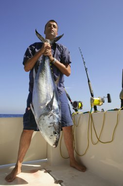 Angler fihing big game bluefin tuna on Mediterranean clipart