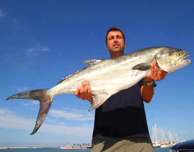 Fisherman holding catch Garrick Lichia Amia clipart