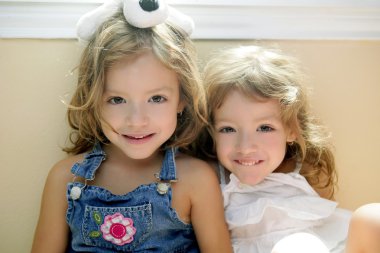 Two little beautiful toddler twin sisters