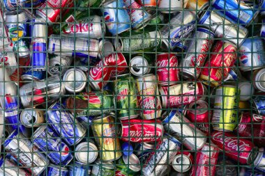 Assorted beverages cans on the trash clipart