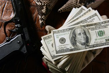 Dollar notes and gun, black pistol clipart