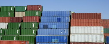 Stacked freight colorful containers, blue sky clipart