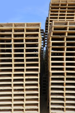 Wooden pallets stacked outdoor blue sky clipart