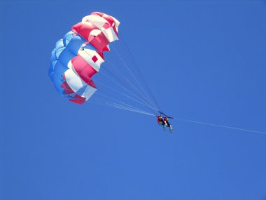 Caribbean beach parachute vacation view from down clipart