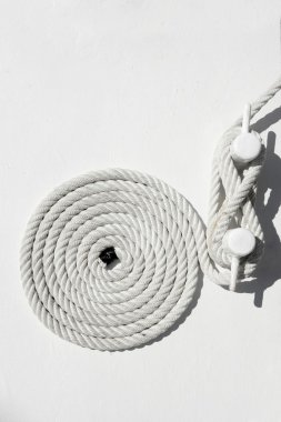 Spiral white sea nautical rope on boat mooring clipart