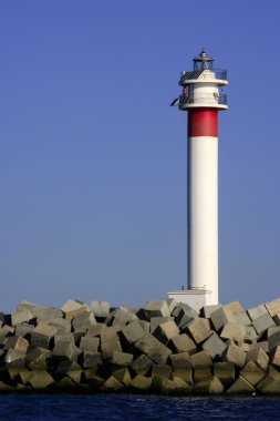 Lighthouse over blue sky in Spain clipart