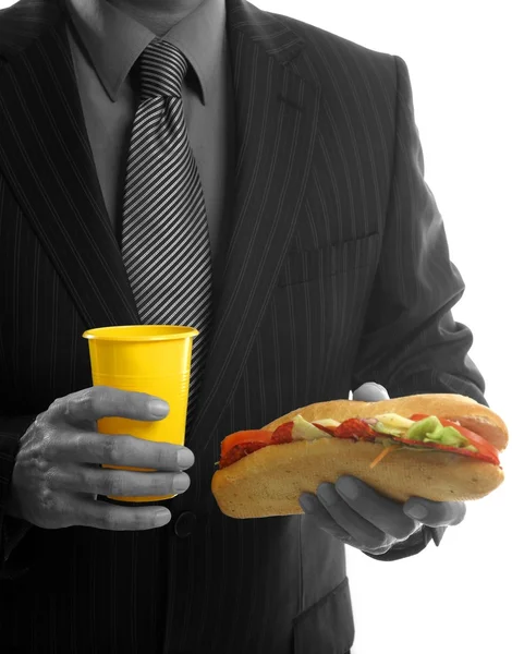 Empresario comiendo chatarra comida rápida —  Fotos de Stock