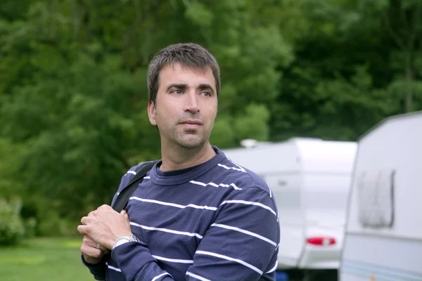 Caucasian man relaxed on camping meadow — Stock Photo, Image