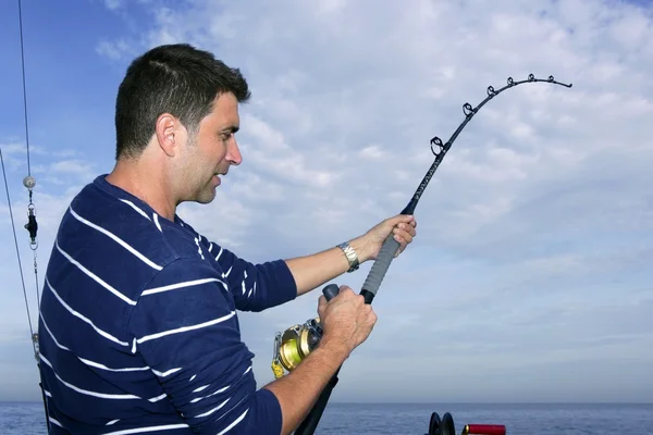 Pescatore pescatore lotta grande asta di pesce e bobina — Foto Stock