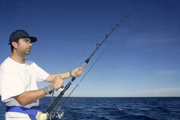 Angler fisherman trolling rod and reel fishing — Stock Photo, Image