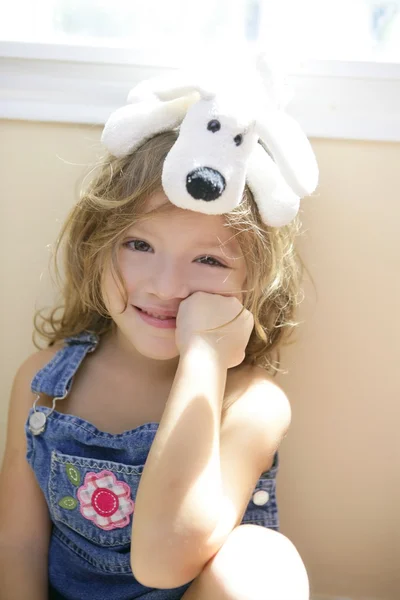 Menina criança feliz com cão de brinquedo sobre a cabeça — Fotografia de Stock