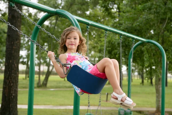 Beautiful little girl playing with swing — Stock Photo, Image
