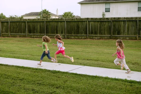 Three sister girls playing running on the park — Stock Photo, Image