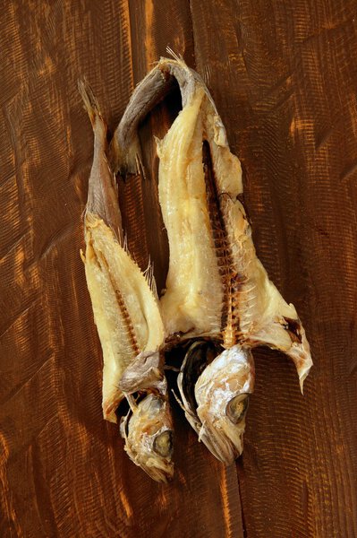 Dried hake fish over wood