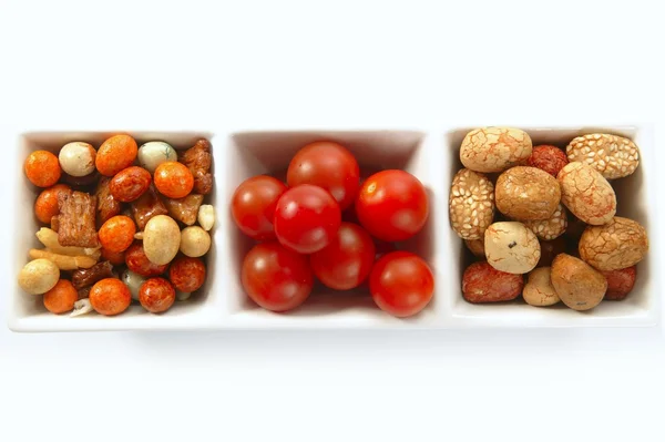 Triple bowl with varied japanese snacks and tomatoes — Stock Photo, Image