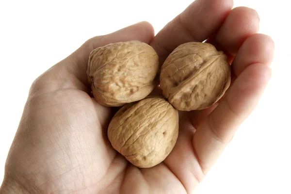 Human hand holding three walnut — Stock Photo, Image