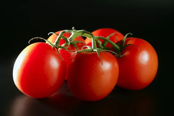 Cluster red tomato over black — Stock Photo, Image