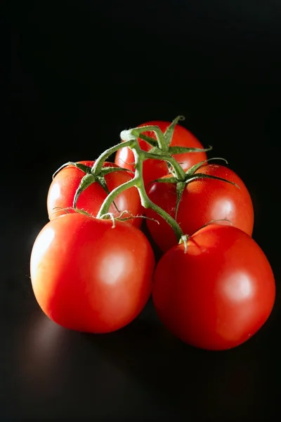 Cluster red tomato over black — Stock Photo, Image