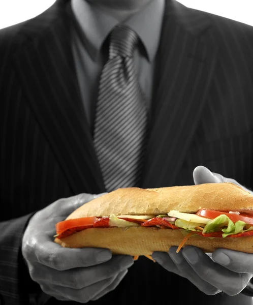 Biznesmen jedzenie śmieci fast foody — Zdjęcie stockowe