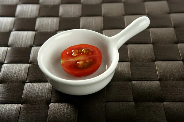 Half cherry tomato in a little dish — Stock Photo, Image