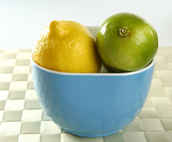 Two lemons in a blue bowl — Stock Photo, Image