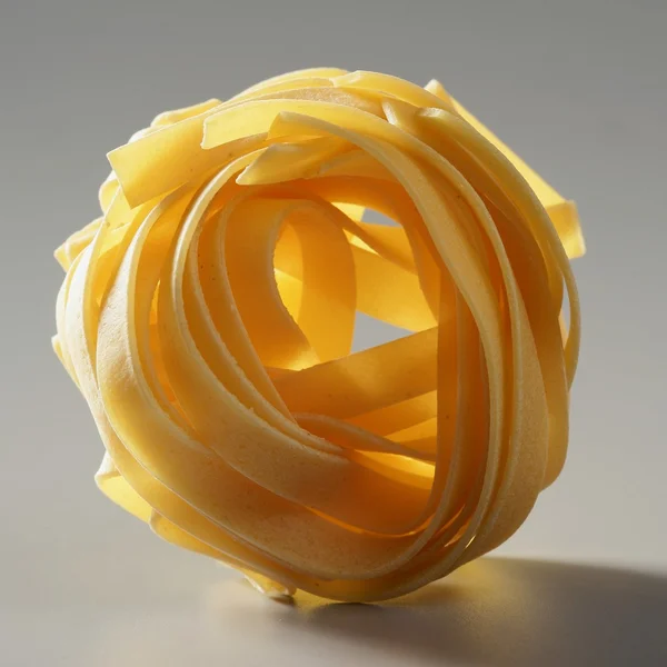 Dried macro noodles yellow pasta, studio shot — Stock Photo, Image