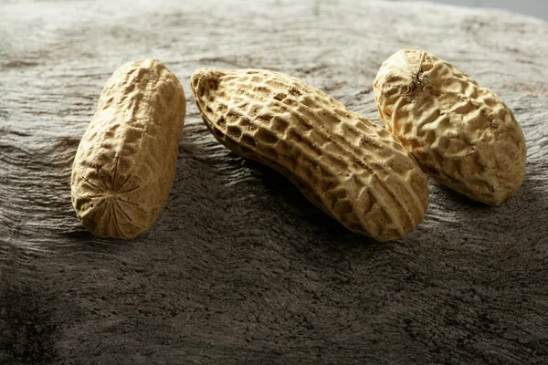 Macro arachidi su sfondo legno — Foto Stock