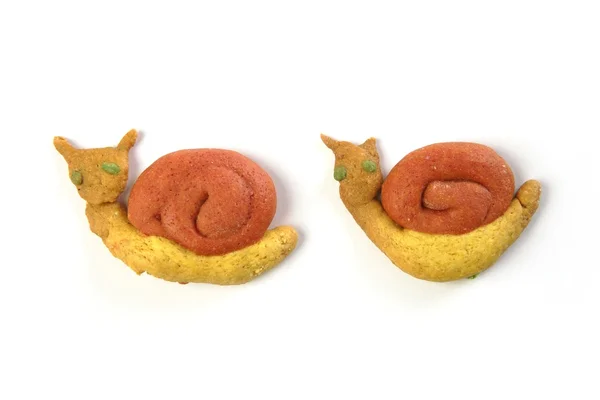 Formas de caracol biscoitos laranja amarelos no branco — Fotografia de Stock