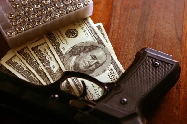 Dollar notes and gun, black pistol — Stock Photo, Image
