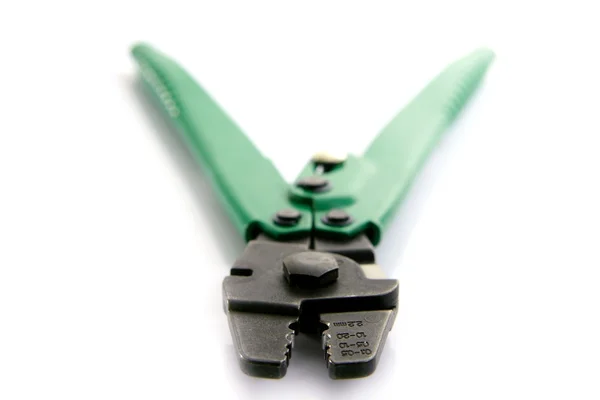 Crimper hand tool, green on white, selective focus — Stock Photo, Image