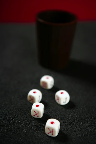 黒いテーブル上の火かき棒ゲームのサイコロ — ストック写真
