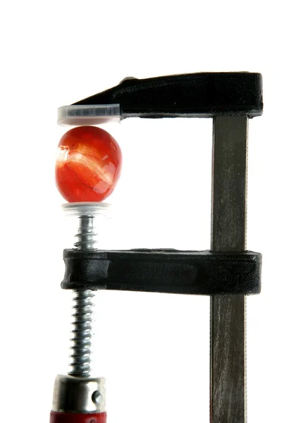 Pedra de cor sob pressão por uma ferramenta de aperto — Fotografia de Stock