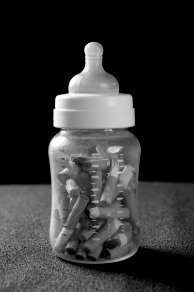 Babyfles vol sigaretten — Stockfoto