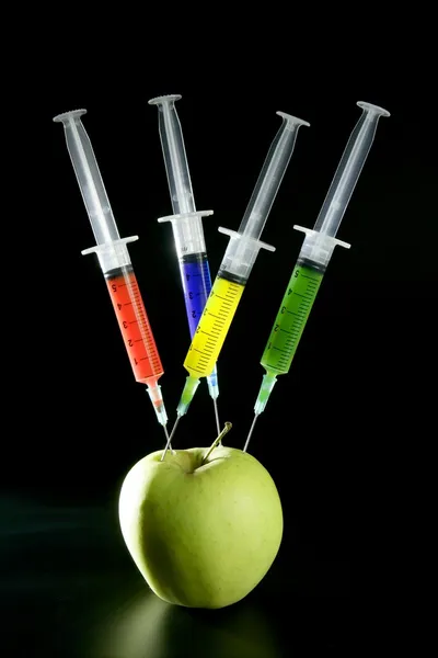 Apple manipulation with syringes — Stock Photo, Image