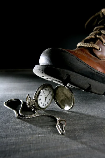 Bota pisando un viejo reloj de bolsillo de plata — Foto de Stock
