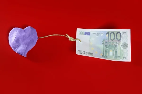 Plastelina purpurowe serce i euro Uwaga — Zdjęcie stockowe