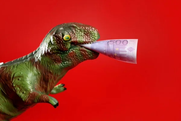 Dinosaure jouet avec billet en euros dans ses lacets — Photo