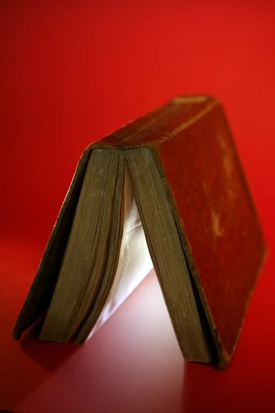 Old aged book close up, light glowing inside — Stock Photo, Image