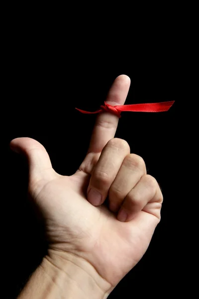 Red tape ribbon, loop tape around human finger — Stock Photo, Image