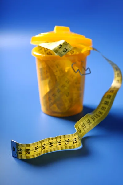 Centimeter tape meter on the trash — Stock Photo, Image