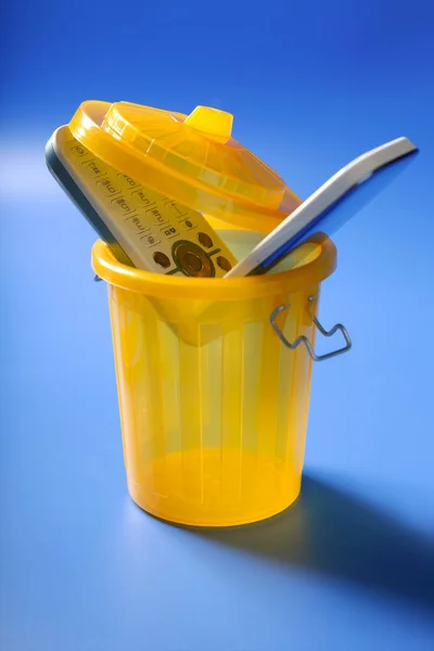 Мобильный телефон в мусорном ведре — стоковое фото