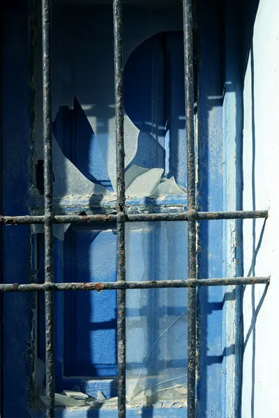 Jail fence over blue mediterranean window — Stock Photo, Image