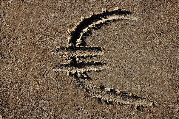 European currency Euro sign on the beach sand