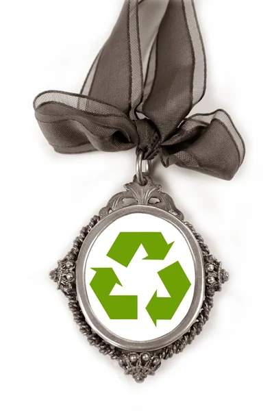 Cameo silver locket with green recycle symbol — Stock Photo, Image
