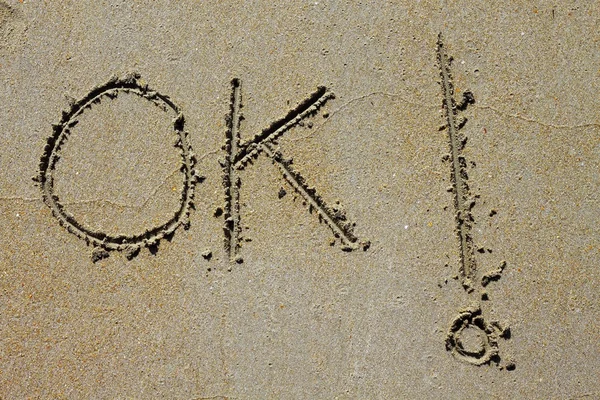 Ok 单词拼写写在湿沙的海滩上 — 图库照片