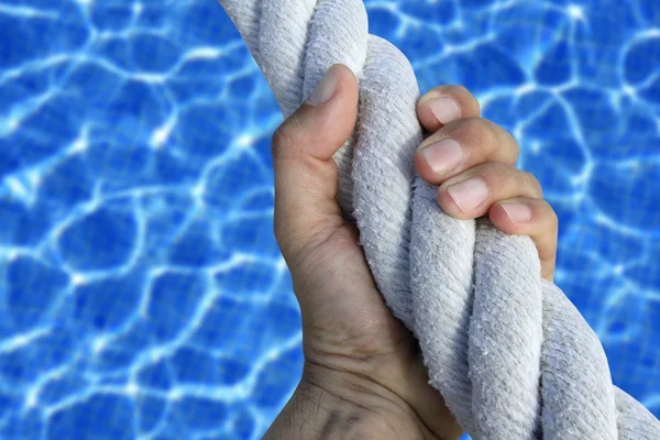 Man hand grab grip sport blue pool big rope — Stock Photo, Image