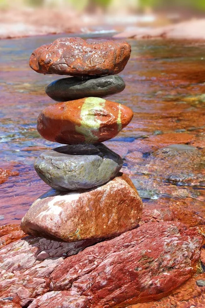Rolling stones stacked red rodeno limestone in river — Stock Photo, Image