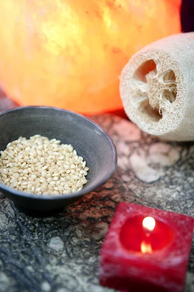 Aromaterapia, vela vermelha, esponja natural marinha do mar e tigela de arroz — Fotografia de Stock