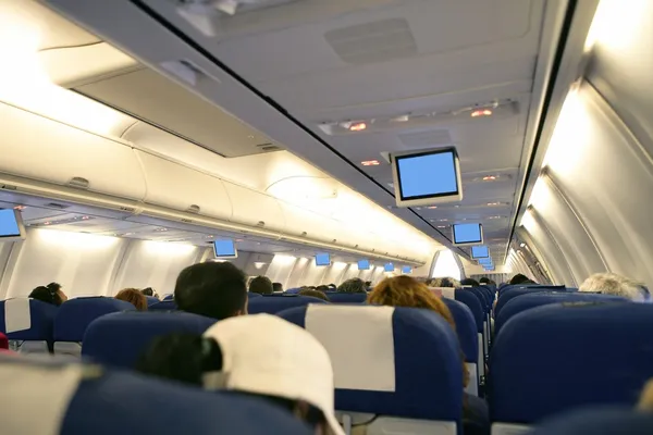 Airplane with passengers interior view — Stock Photo, Image